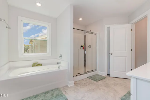 a bathroom with a bathtub and a shower