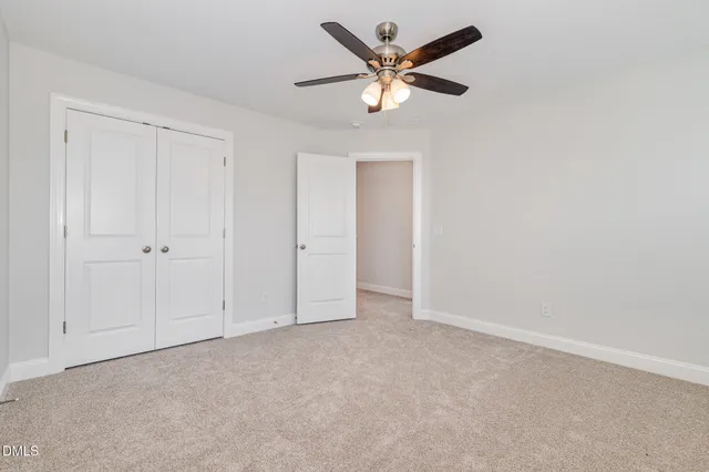 an empty room with a ceiling fan