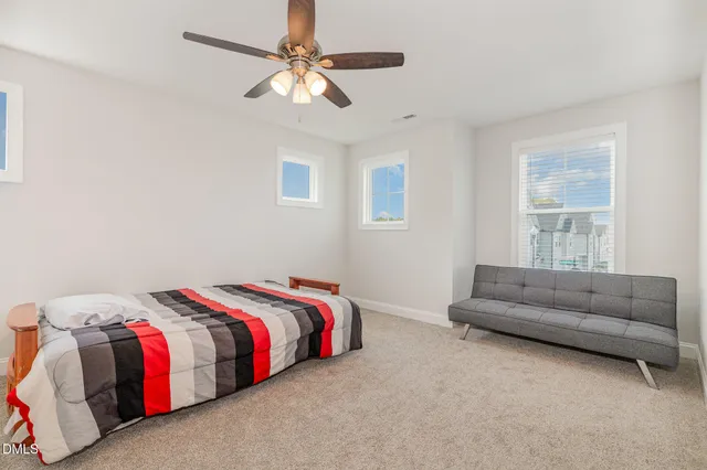 a bedroom with a bed and a couch