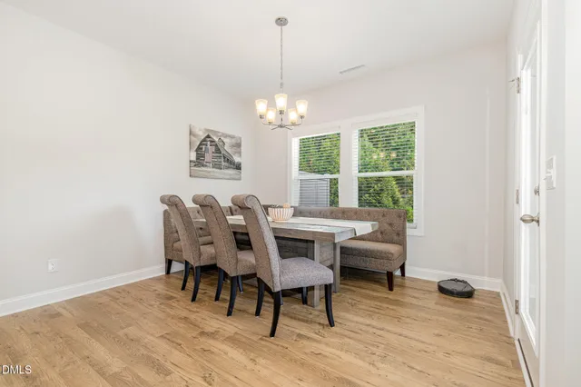 a dining room with furniture a window and wooden floor