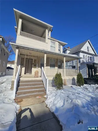 an empty room with wooden floor and cabinet