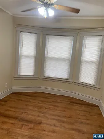 a kitchen with white cabinets and appliances