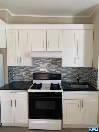 a view of walk in closet with wooden floor