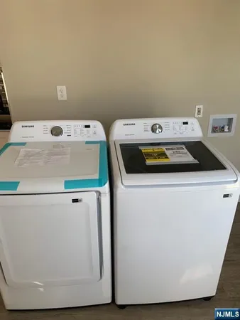 a bathroom with a sink a toilet a mirror and shower