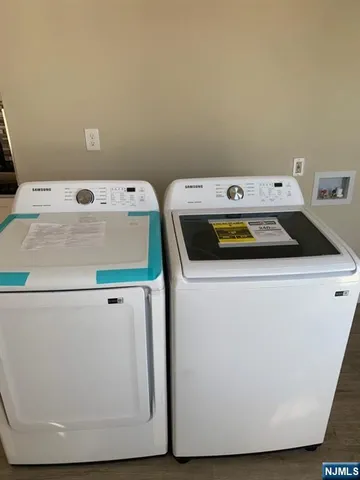 a bathroom with a sink a toilet a mirror and shower