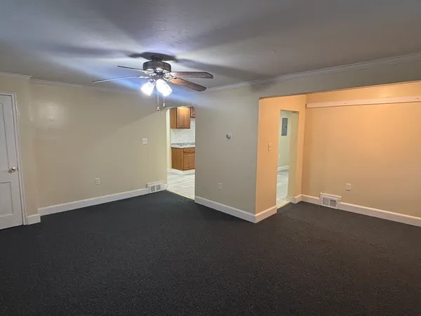 a view of a livingroom with a ceiling fan and window