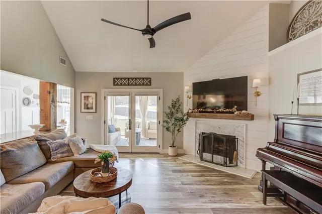 a living room with furniture a flat screen tv and a fireplace