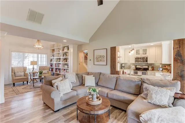 a living room with furniture and view of kitchen