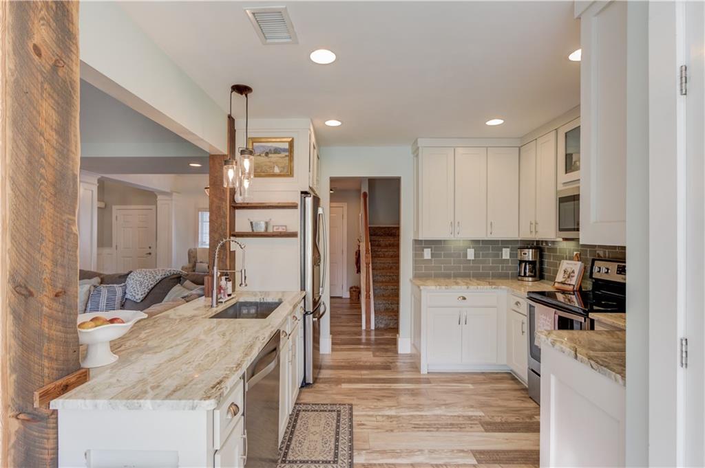 18 Raven Ridge Jefferson, GA 30549 - Photo 13 of 47 a kitchen with granite countertop a refrigerator stove and sink