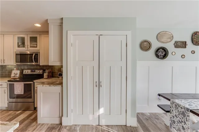 a kitchen with stainless steel appliances granite countertop a refrigerator and a stove top oven