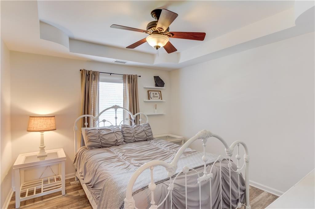 18 Raven Ridge Jefferson, GA 30549 - Photo 23 of 47 a bedroom with a bed and a chandelier