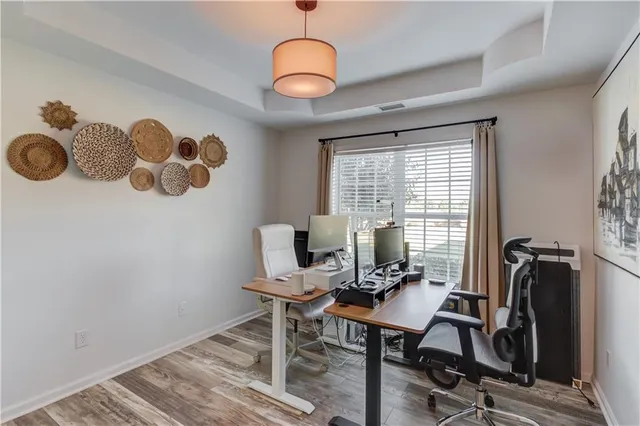a view of a workspace with furniture and a window
