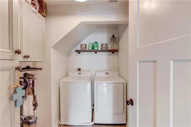 a view of storage and utility room with washer and dryer