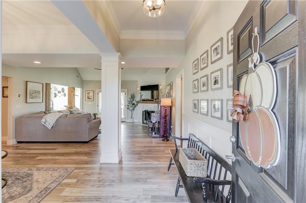 18 Raven Ridge Jefferson, GA 30549 - Photo 6 of 47 a living room with furniture a flat screen tv and a floor to ceiling window