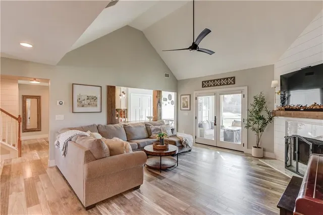 a living room with fireplace furniture and a wooden floor