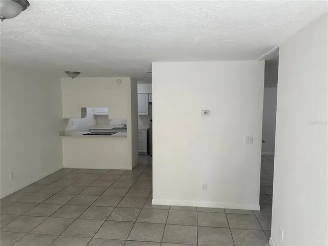 a view of an empty room and fire place