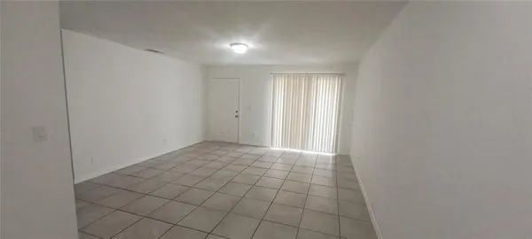 a kitchen with a refrigerator and white cabinets