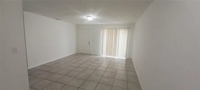 a kitchen with a refrigerator and white cabinets