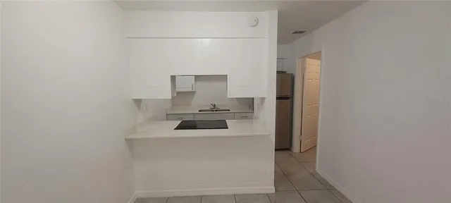 a kitchen with a refrigerator and cabinets