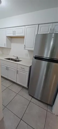 a kitchen with a refrigerator and cabinets