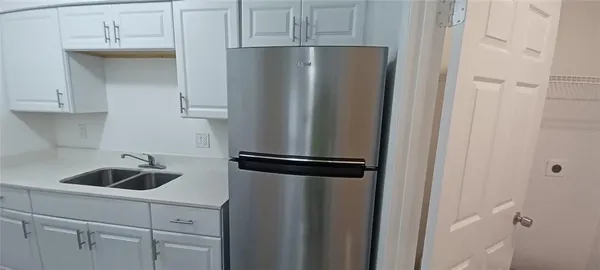 a kitchen with a refrigerator and cabinets
