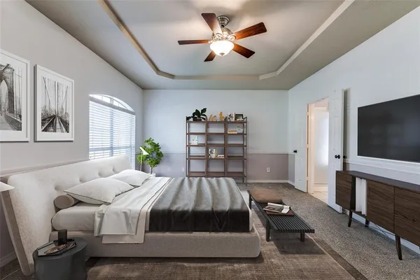 a spacious bedroom with a bed and a flat screen tv