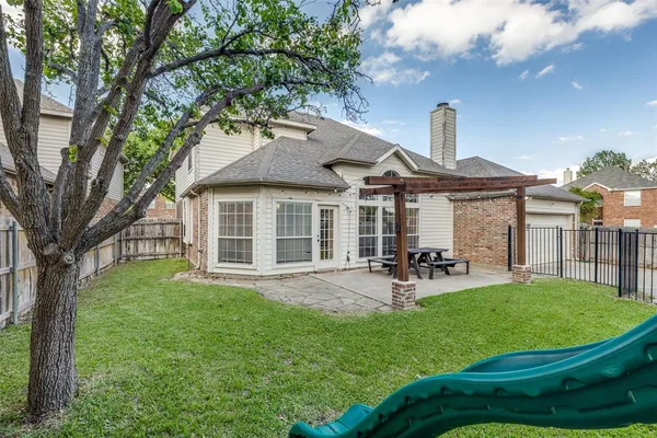 a front view of a house with sitting area and garden