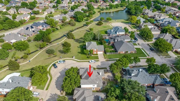 an aerial view of a house with a yard and lake view