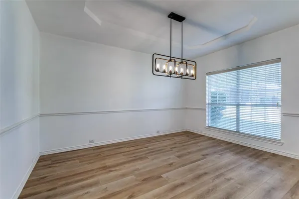 a view of a room with windows and cabinet