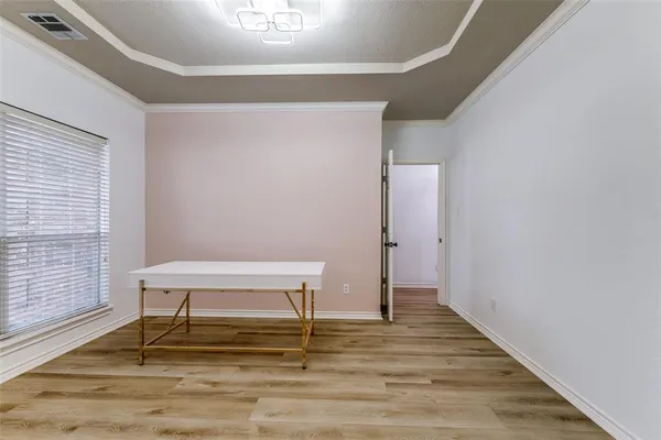 a view of a livingroom with wooden floor and a window