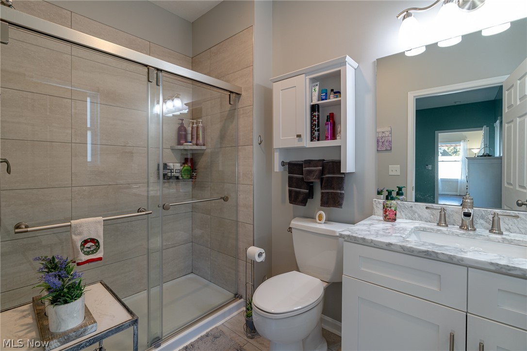 7462 Pearl Road Cleveland, OH 44130 - Photo 17 of 32 Master on suite bathroom with large tiled shower, glass doors, tile floor and granite topped vanity.