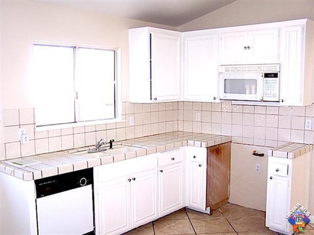 1241 Kings Road Palmdale, CA 93551 - Photo 8 of 21 a kitchen with a sink and cabinets