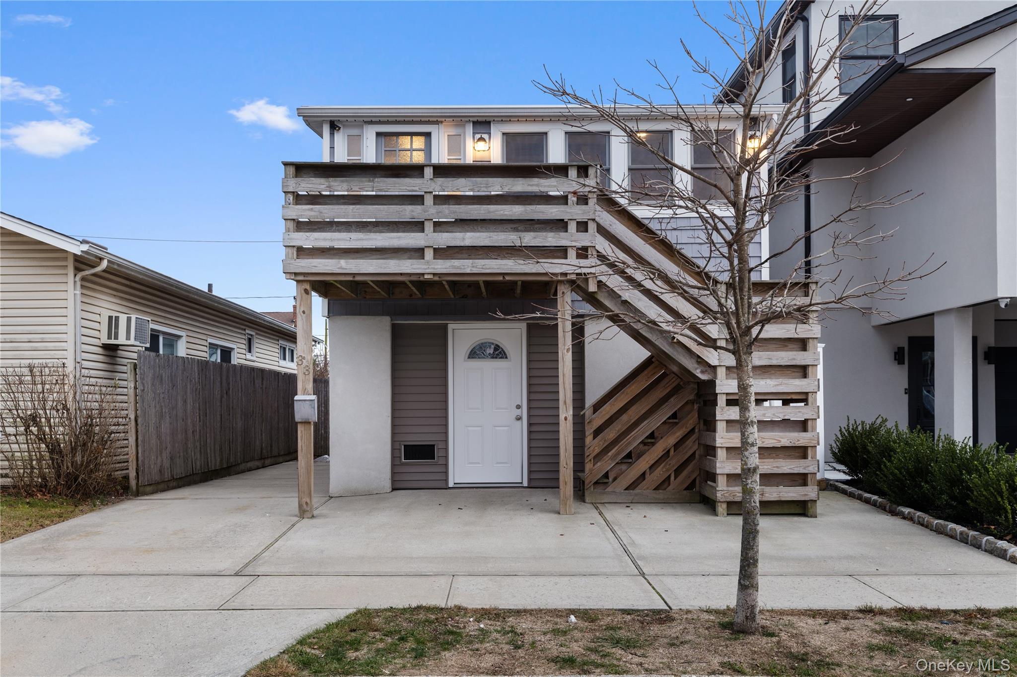 View of exterior entry with a wall unit AC