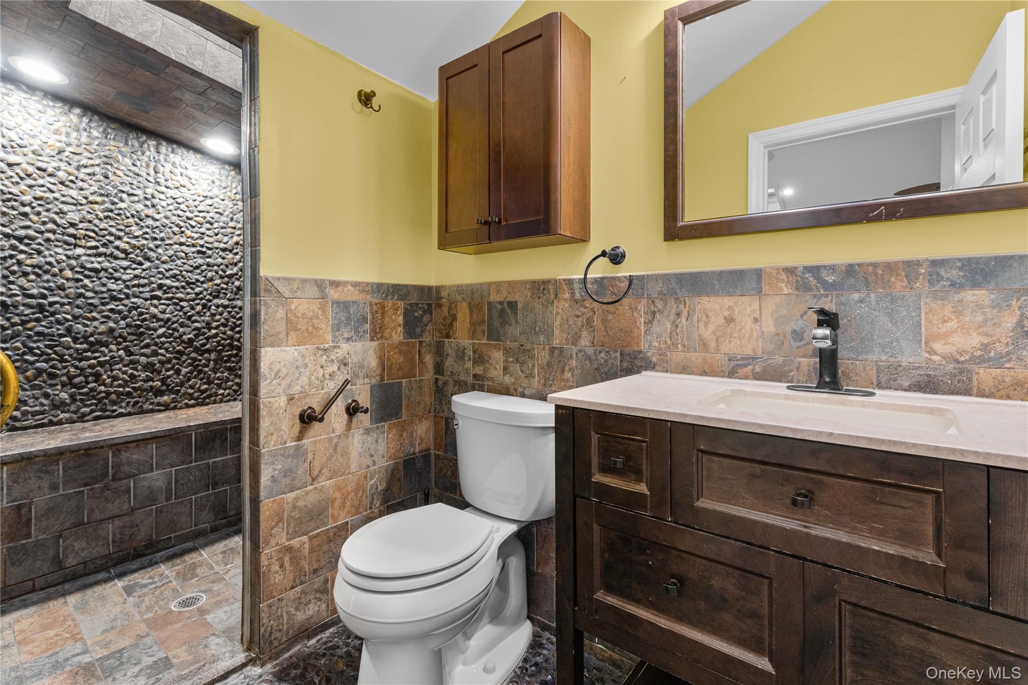 33 Kent Road Island Park, NY 11558 - Photo 12 of 26 a bathroom with a sink a toilet and mirror