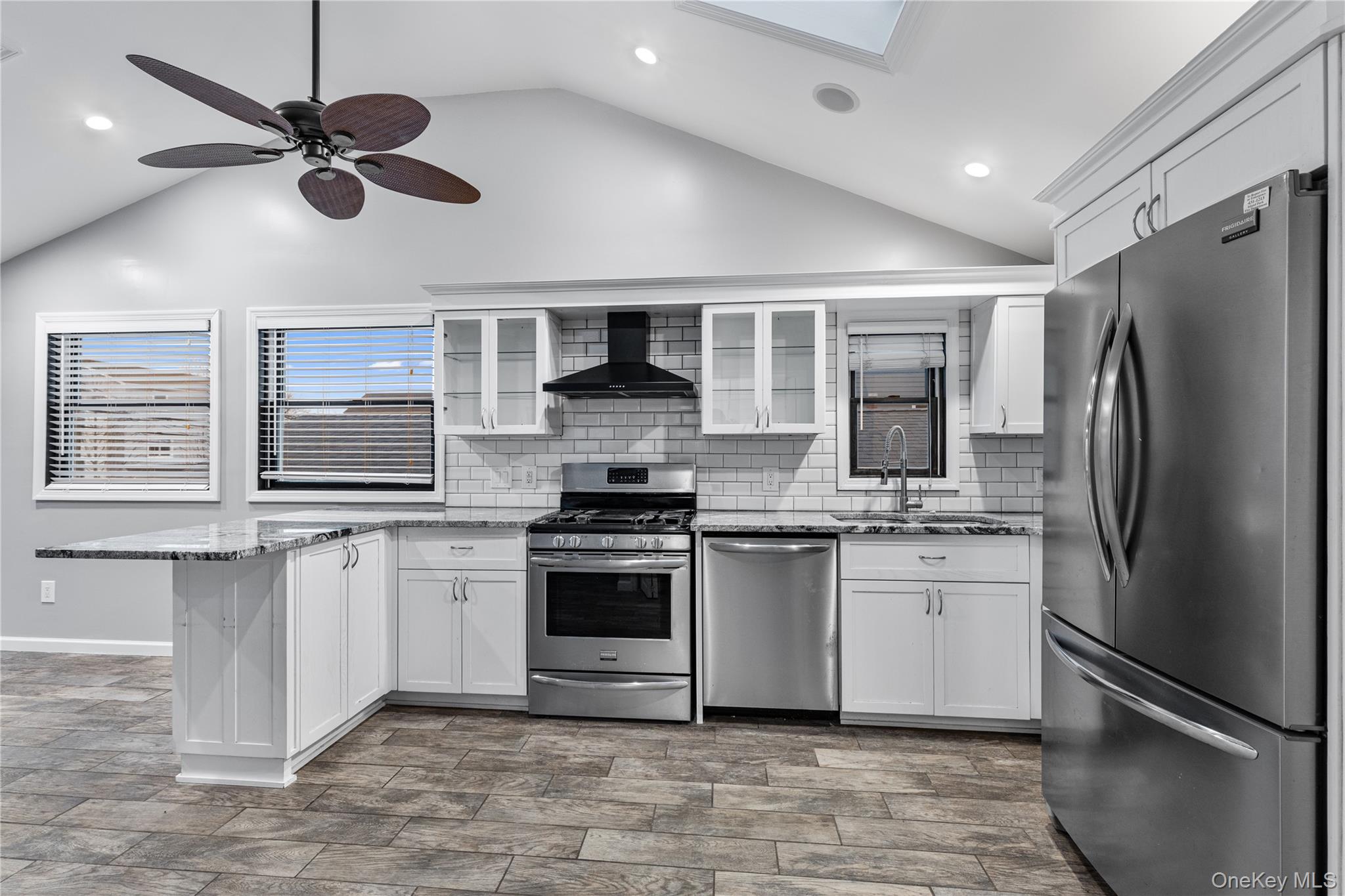 33 Kent Road Island Park, NY 11558 - Photo 2 of 26 a kitchen with stainless steel appliances granite countertop a stove sink microwave and refrigerator