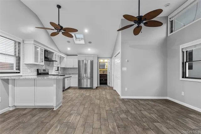 a view of a kitchen with a sink stainless steel appliances and window