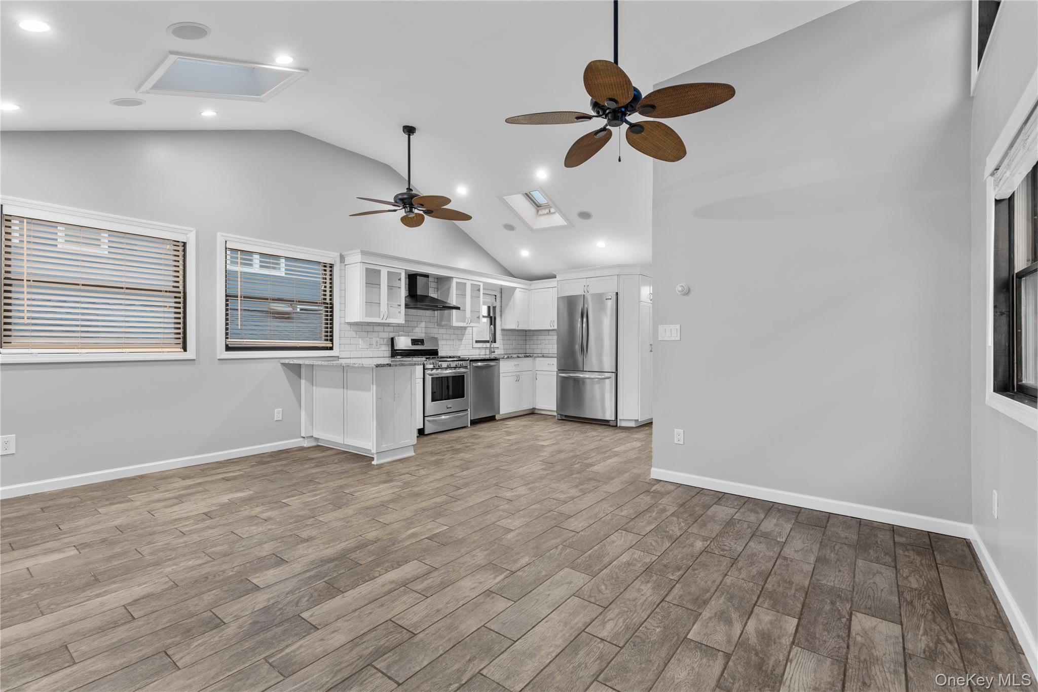 33 Kent Road Island Park, NY 11558 - Photo 26 of 26 a view of a kitchen with a sink and dishwasher cabinets with wooden floor