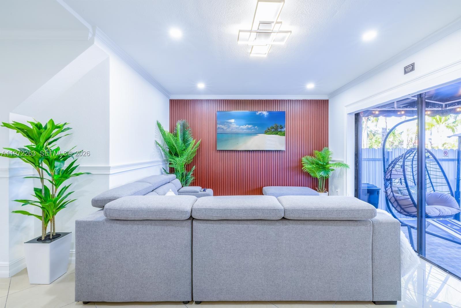 15445 Southwest 57th Street Miami, FL 33193 - Photo 70 of 78 a living room with furniture potted plant and a window