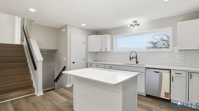 a white toilet sitting next to a bathroom sink