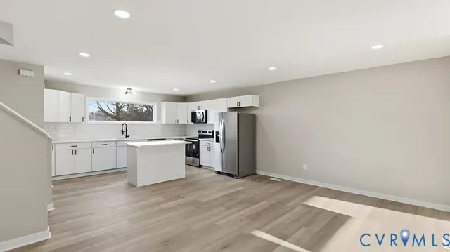 an empty room with wooden floor and sliding door