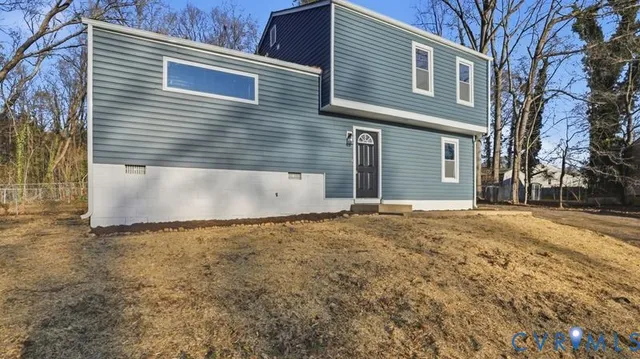 a view of a hallway with wooden floor and entryway