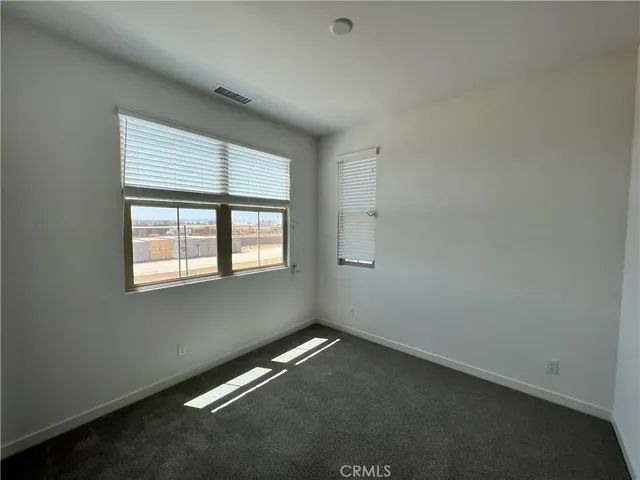 an empty room with a empty space and a window