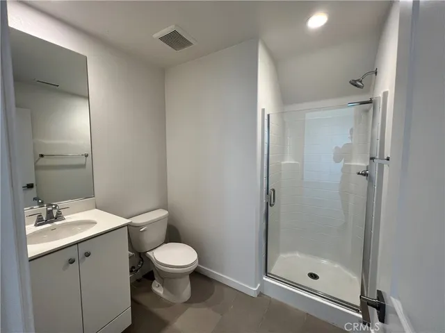 a bathroom with a toilet a sink and shower