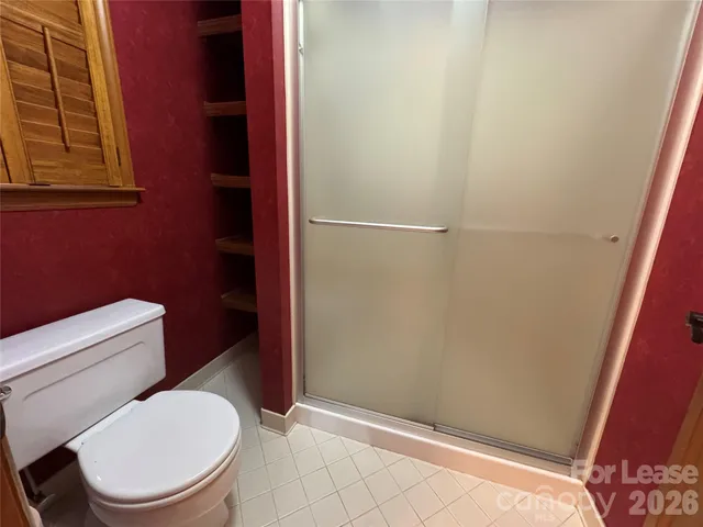 a white toilet sitting next to a shower