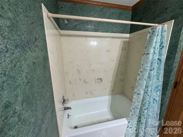 a bathroom with a bathtub and shower