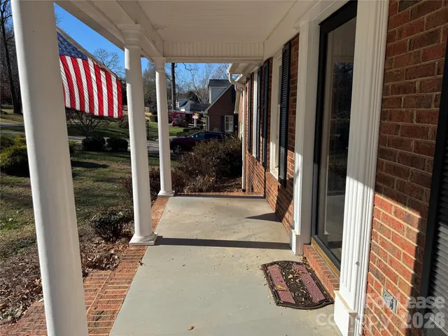 a view of a door with a floor to ceiling window and potted plants