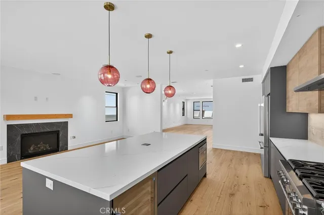 a view of kitchen island with sink microwave and stove