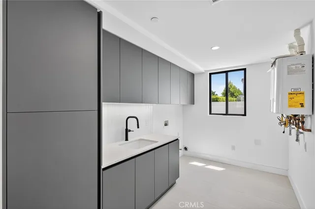 a kitchen with a sink a window and stainless steel appliances