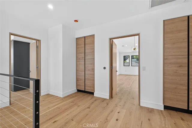 a view of a hallway with wooden floor