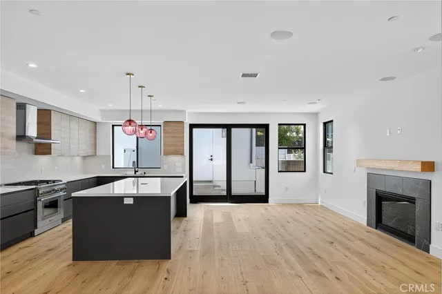 a large kitchen with stainless steel appliances granite countertop a sink and a stove